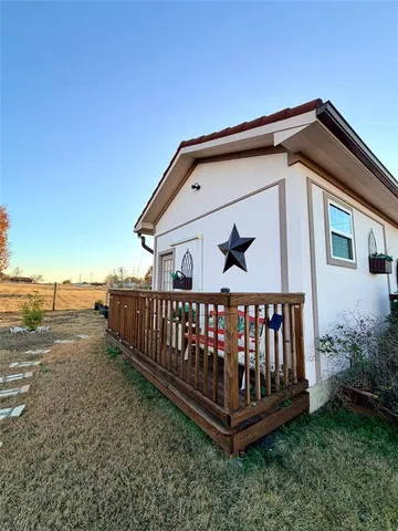 a view of a yard with wooden fence