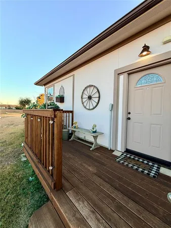 a view of a porch with wooden floor