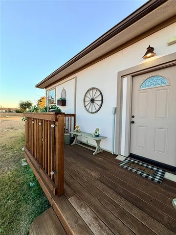 a view of a porch with wooden floor