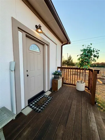 a view of a balcony with wooden floor
