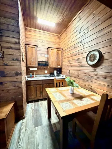 a kitchen with stainless steel appliances kitchen island granite countertop wooden cabinets a stove and a sink