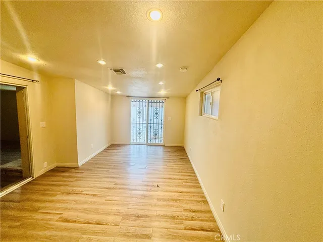 a view of a hallway with wooden floor