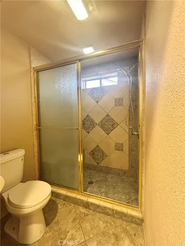 a bathroom with a toilet and shower