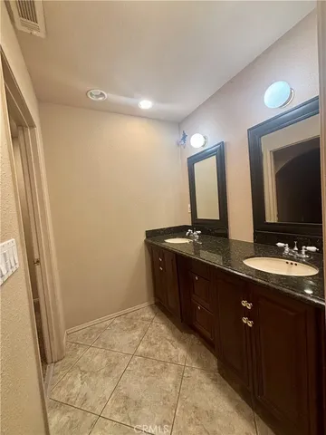 a bathroom with a double vanity sink and mirror