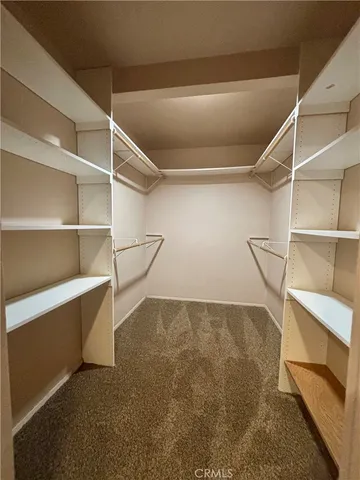 a view of an empty room with empty shelves