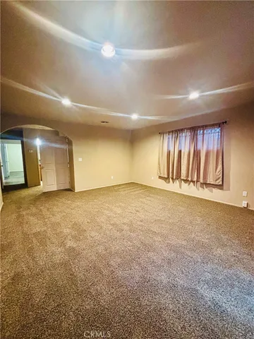 an empty room with a empty space and windows