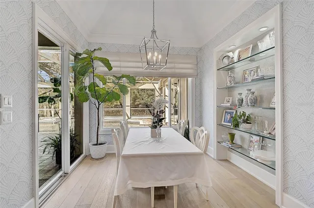 a living room with furniture a flat screen tv and a large window