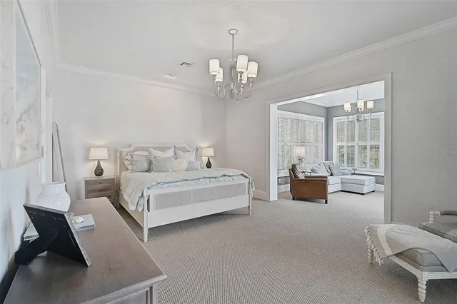 a bedroom with a bed a mirror on dresser and a dresser