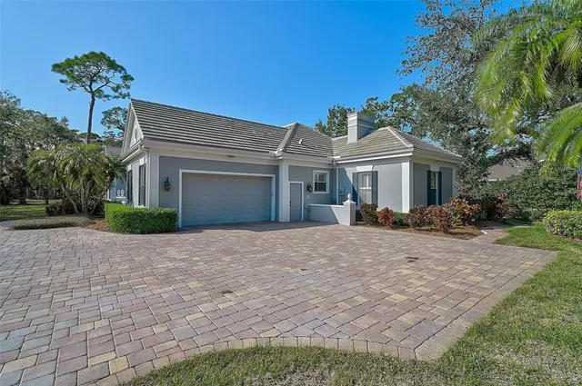 a view of a tennis ground with large trees