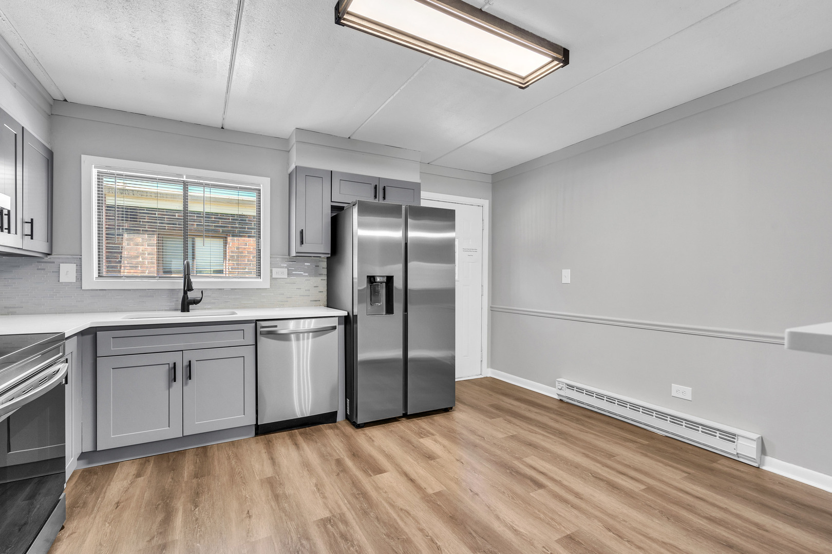 942 North Rohlwing Road, Unit 201E Addison, IL 60101 - Photo 11 of 25 a kitchen with stainless steel appliances a refrigerator sink and cabinets