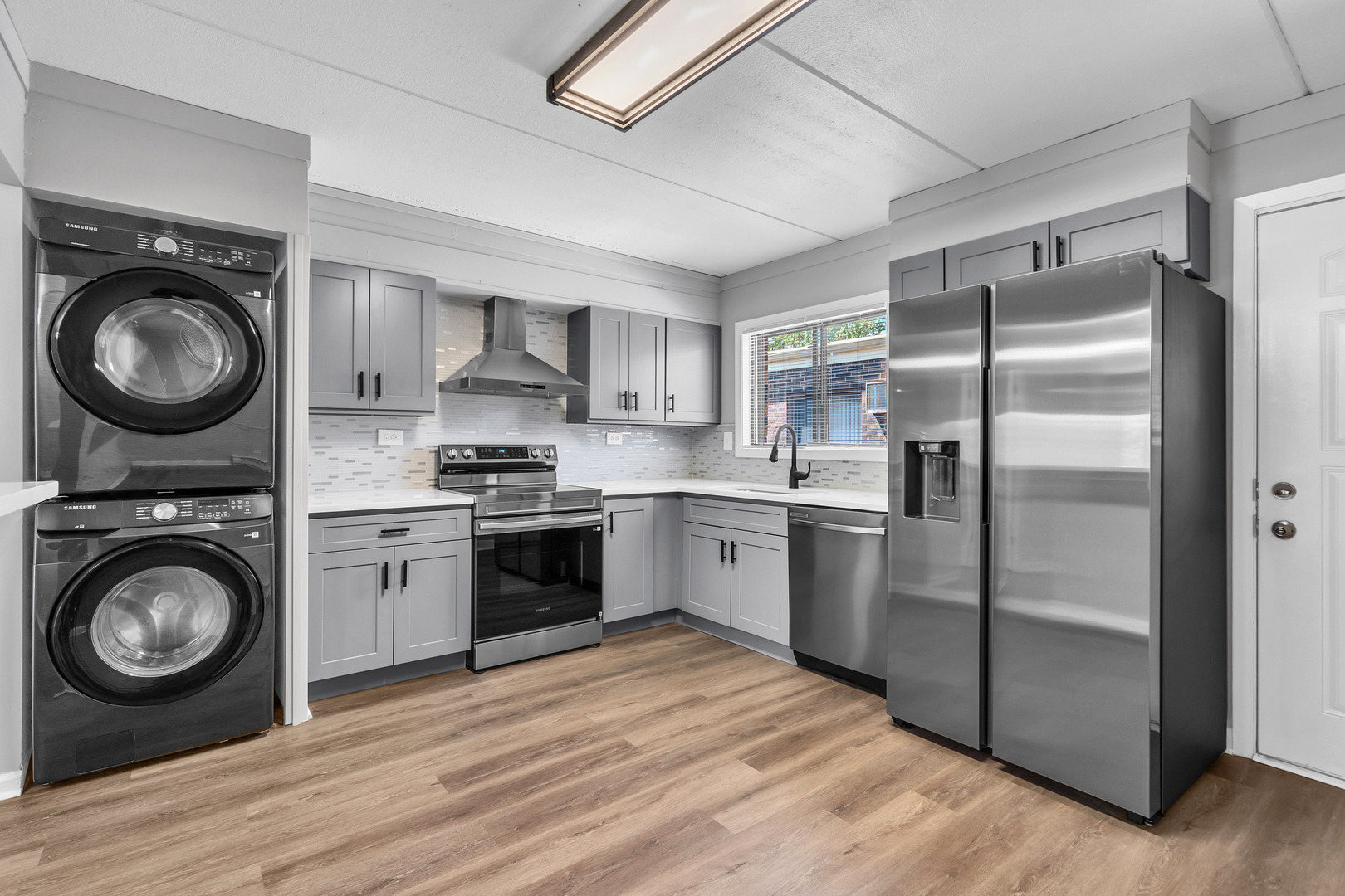 942 North Rohlwing Road, Unit 201E Addison, IL 60101 - Photo 12 of 25 a kitchen with a refrigerator sink and wooden cabinets