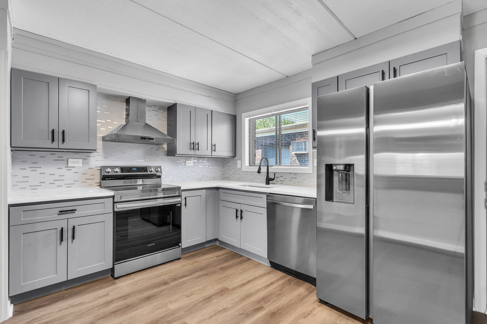 942 North Rohlwing Road, Unit 201E Addison, IL 60101 - Photo 13 of 25 a kitchen with stainless steel appliances granite countertop a stove a sink and a refrigerator