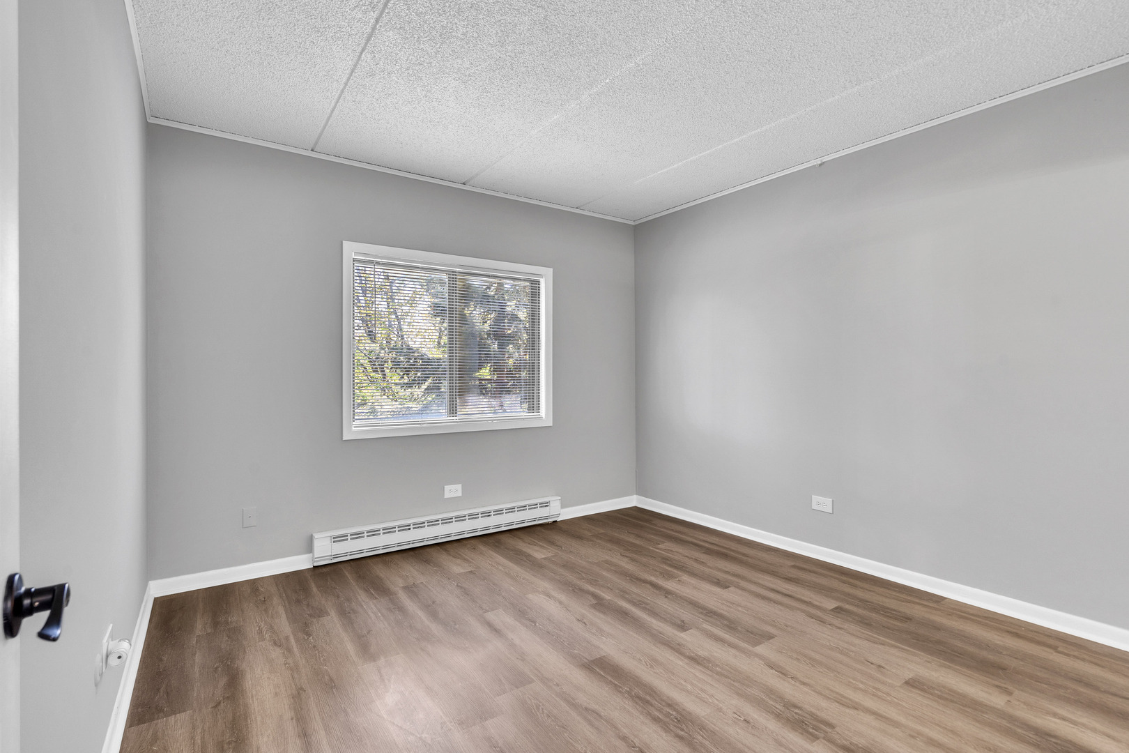 942 North Rohlwing Road, Unit 201E Addison, IL 60101 - Photo 15 of 25 a view of an empty room with wooden floor and a window