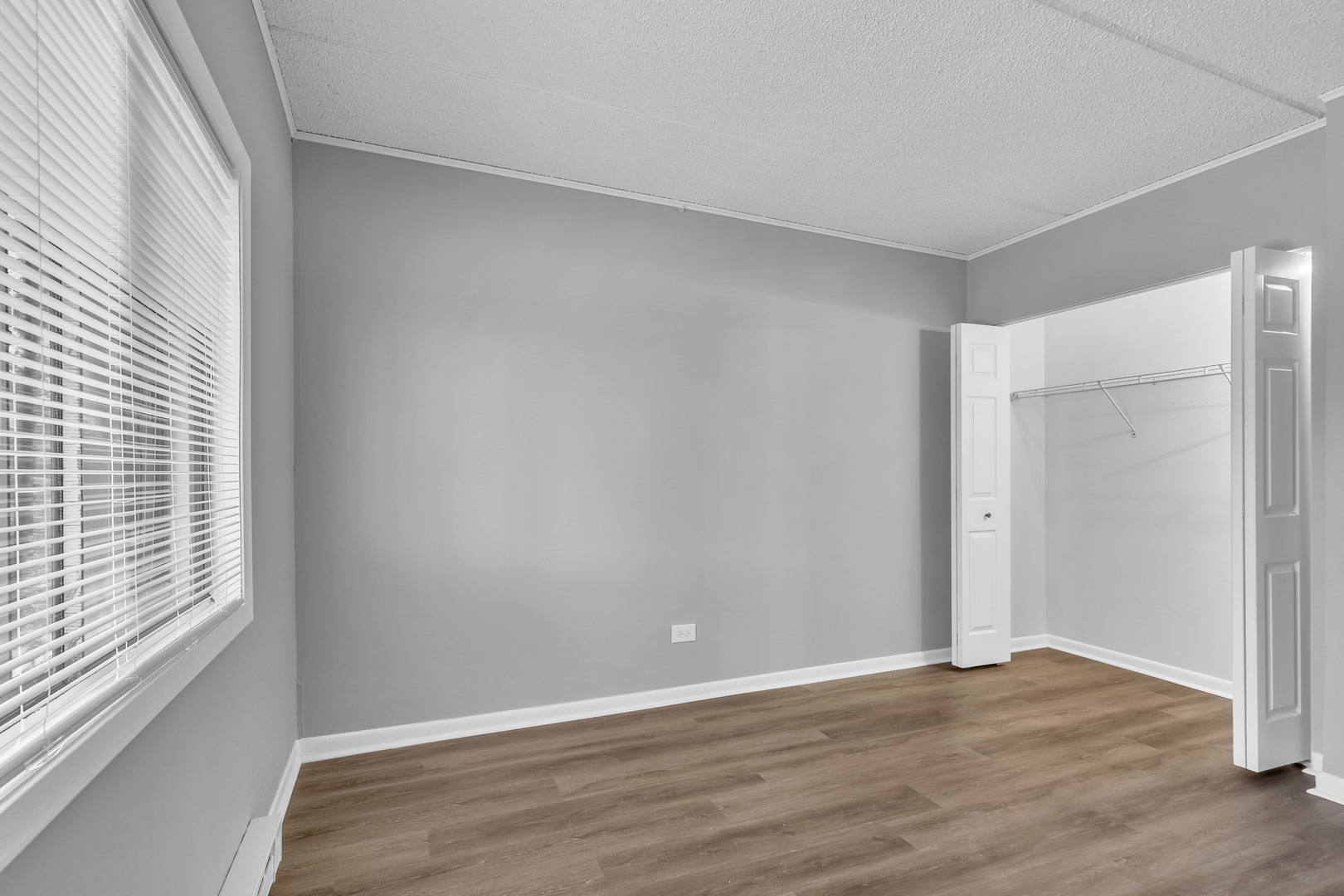 942 North Rohlwing Road, Unit 201E Addison, IL 60101 - Photo 16 of 25 a view of an empty room with wooden floor and a window