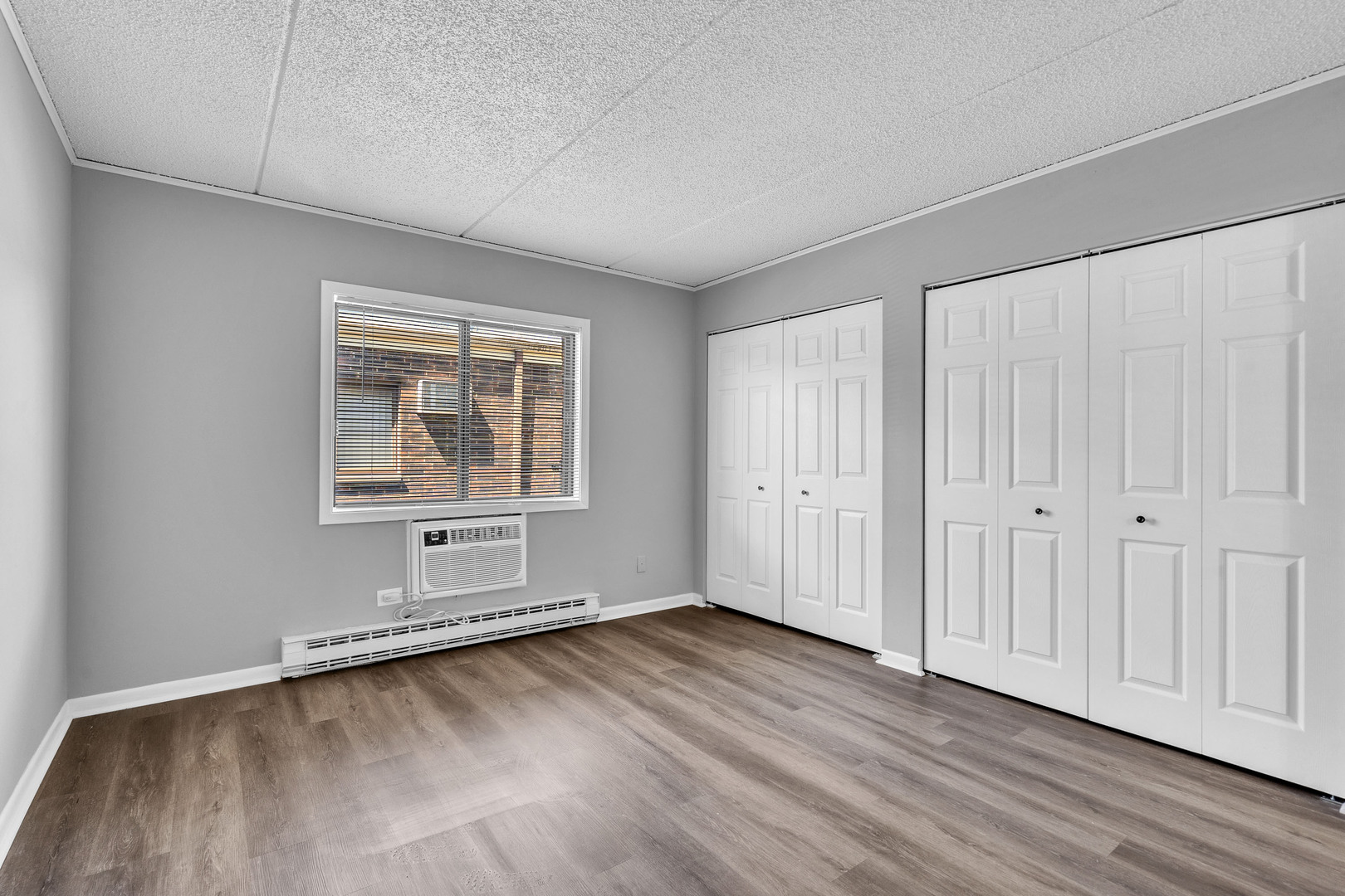 942 North Rohlwing Road, Unit 201E Addison, IL 60101 - Photo 19 of 25 an empty room with wooden floor and windows
