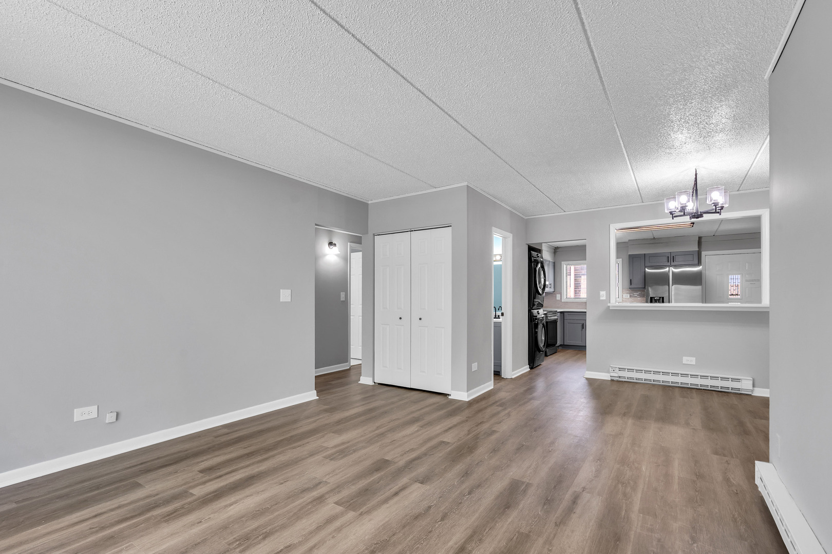 942 North Rohlwing Road, Unit 201E Addison, IL 60101 - Photo 3 of 25 an empty room with wooden floor and windows
