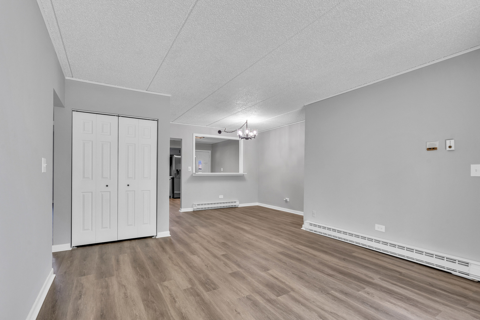 942 North Rohlwing Road, Unit 201E Addison, IL 60101 - Photo 4 of 25 a view of an empty room with wooden floor and a window