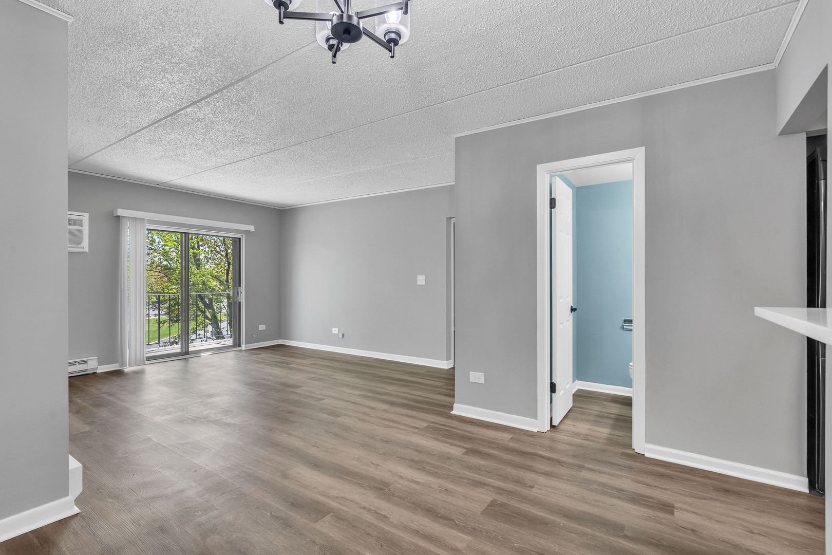 942 North Rohlwing Road, Unit 201E Addison, IL 60101 - Photo 7 of 25 a view of an empty room with wooden floor and a window