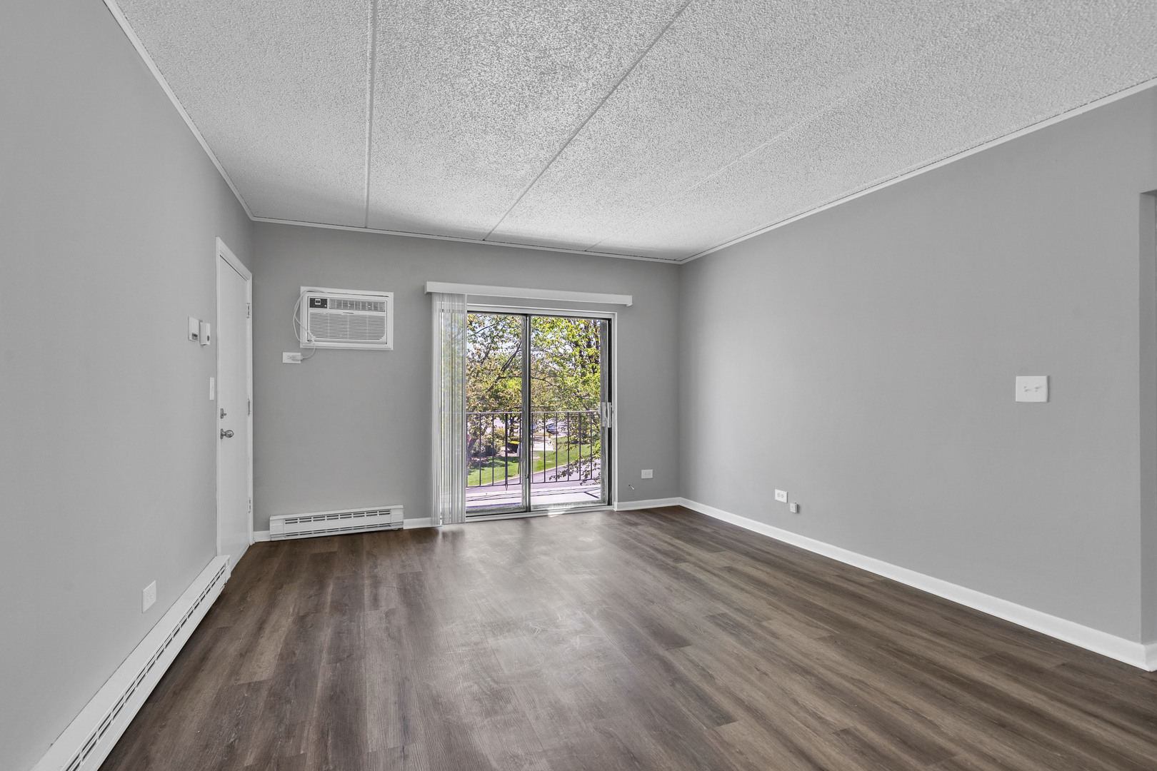 942 North Rohlwing Road, Unit 201E Addison, IL 60101 - Photo 8 of 25 a view of an empty room with wooden floor and a window