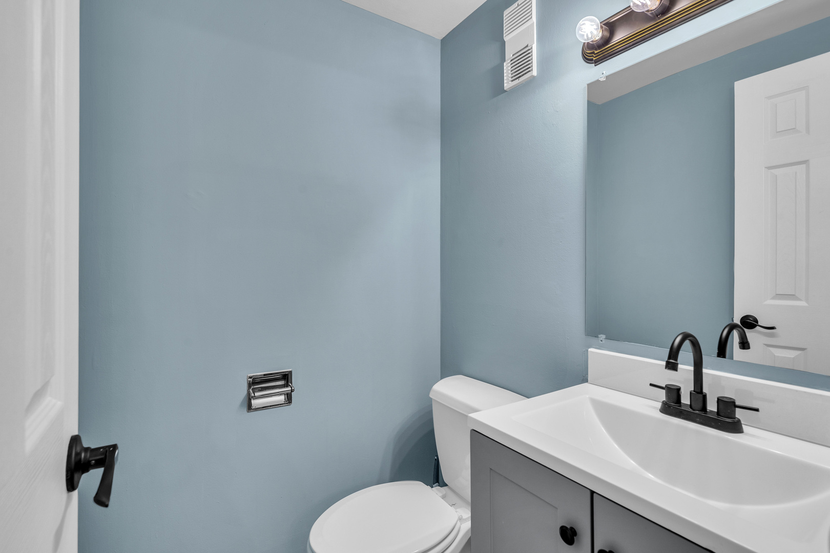 942 North Rohlwing Road, Unit 201E Addison, IL 60101 - Photo 9 of 25 a bathroom with a toilet sink and mirror