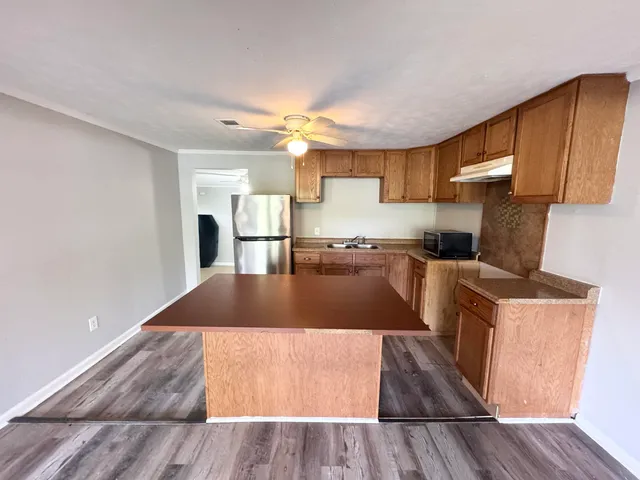 a kitchen with granite countertop a stove and a sink