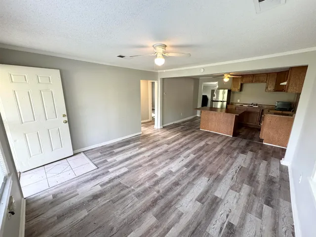 a view of a livingroom with furniture wooden floor and window