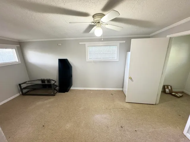 a view of room with workspace and windows