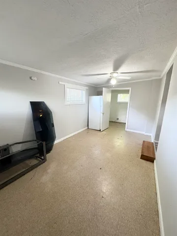 a view of a livingroom with furniture and a window