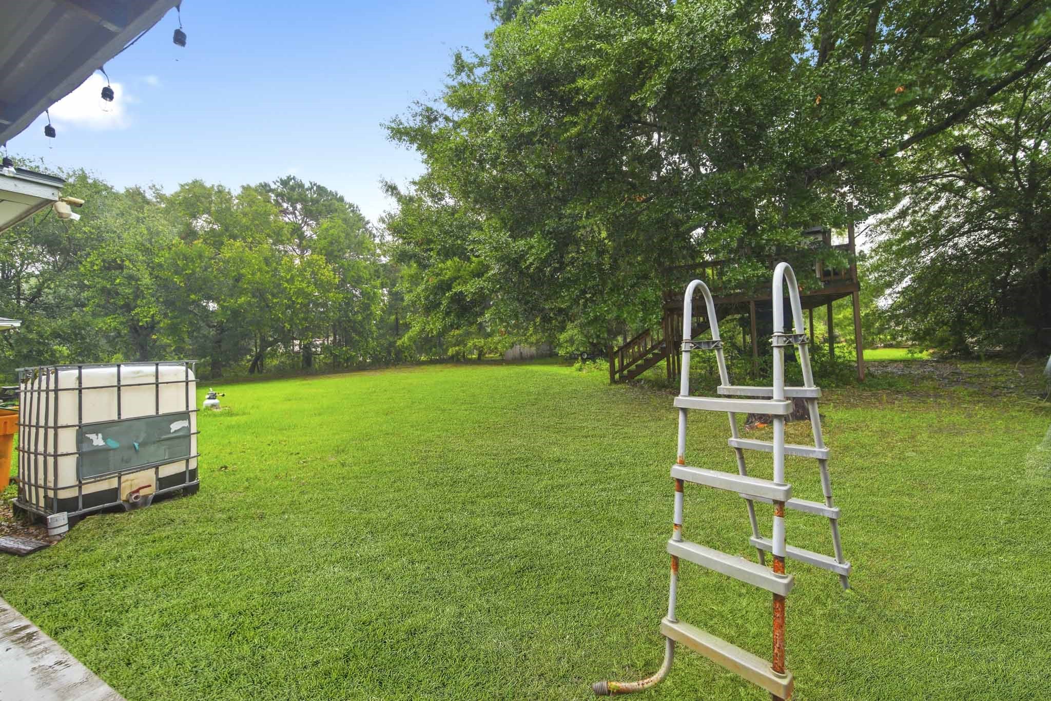 731 Meneley Road Winnie, TX 77665 - Photo 27 of 27 a front view of a house with a yard