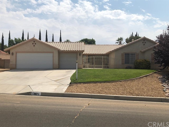 12971 Tawya Road Apple Valley, CA 92308 - Photo 1 of 1 a front view of a house next to a yard
