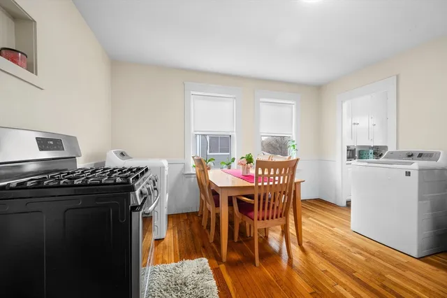 a dining room with furniture and wooden floor