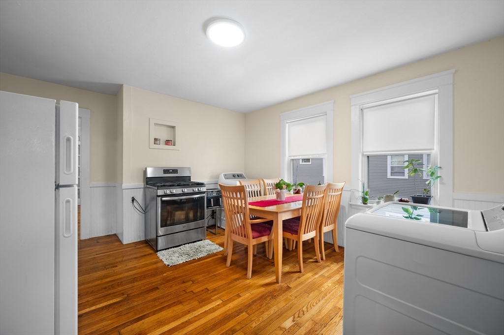 19 Oliver Street, Unit 2 Milford, MA 01757 - Photo 2 of 20 a dining room with a table chairs and a kitchen view
