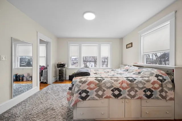 a bedroom with a large bed and a window