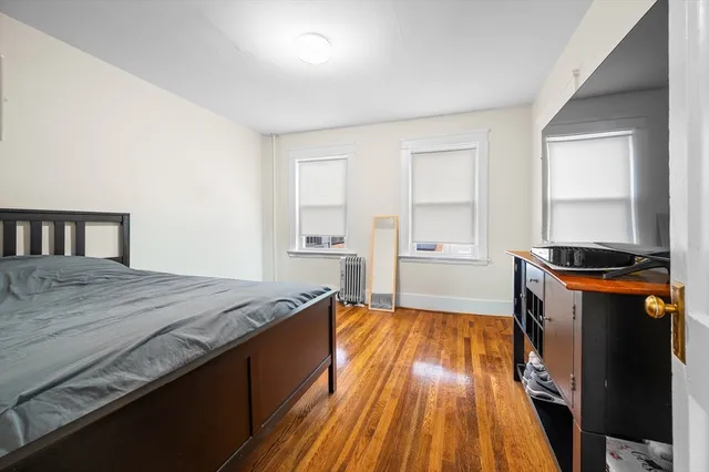 a spacious bedroom with a bed and a dresser