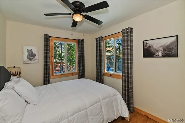 a bedroom with a large bed and a window