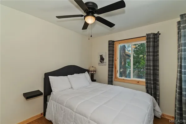 a bedroom with a bed and window