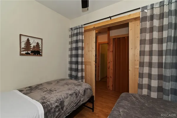 a bedroom with a bed and a painting on the wall