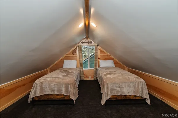 a bedroom with two bunk beds and a chandelier