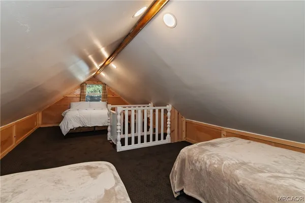 a large bed sitting in a bedroom next to a window