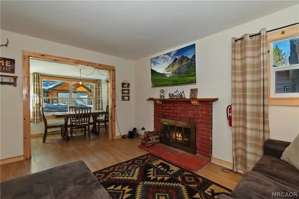 a living room with furniture a rug and a fireplace