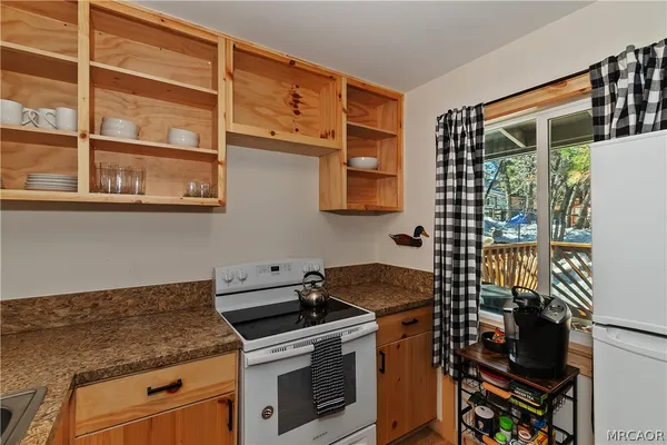 a kitchen with stainless steel appliances granite countertop a stove and a microwave