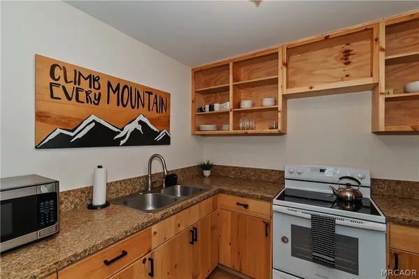 a kitchen with stainless steel appliances granite countertop a stove and a sink
