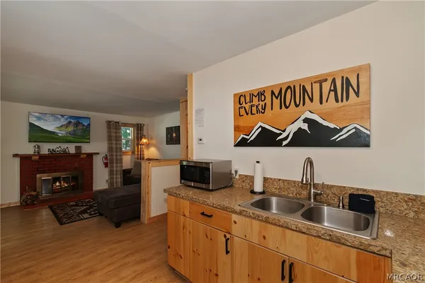 a kitchen with stainless steel appliances granite countertop a sink and a wooden cabinets