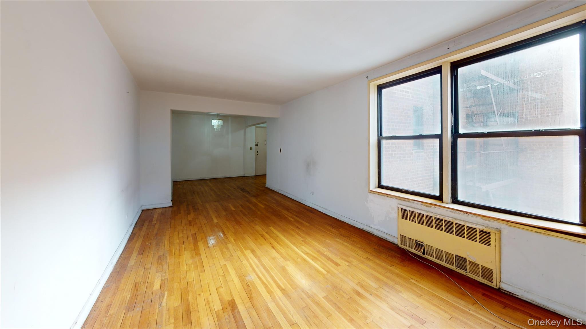 33-26 92nd Street, Unit 2T Queens, NY 11372 - Photo 4 of 10 a view of a hallway with wooden floor