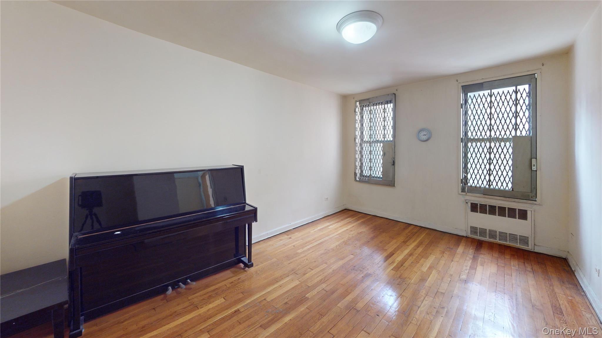 33-26 92nd Street, Unit 2T Queens, NY 11372 - Photo 8 of 10 a view of a livingroom with wooden floor