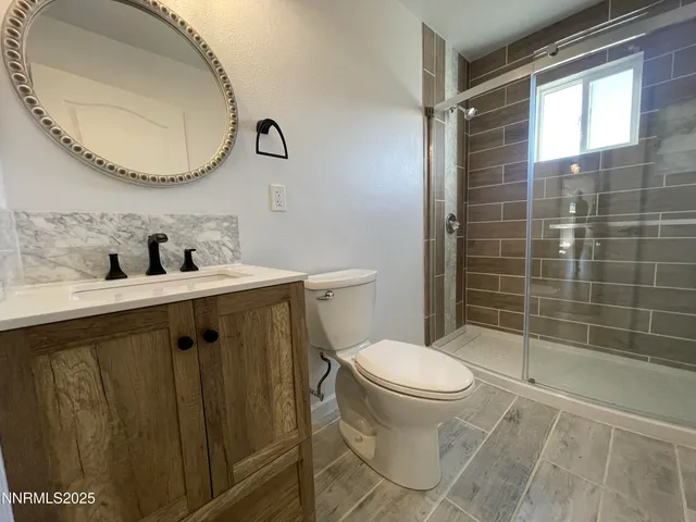 a bathroom with a toilet a sink and mirror