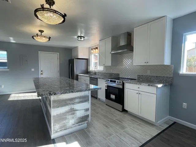 a kitchen with stainless steel appliances granite countertop a stove and a sink