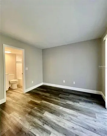 a view of room with wooden floor