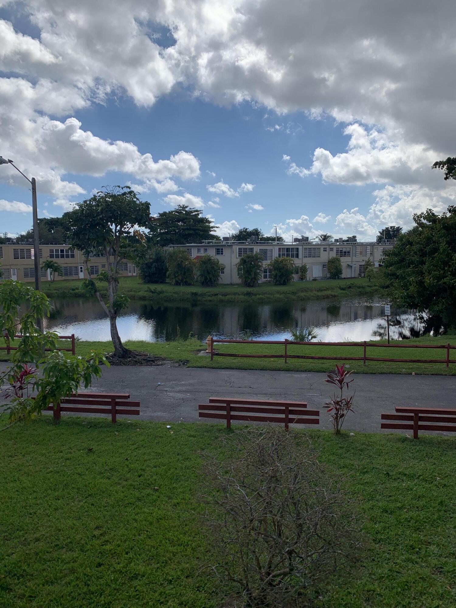 a park view with a bench in a lake