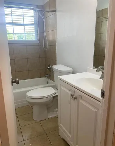 a white toilet sitting next to a bathroom sink